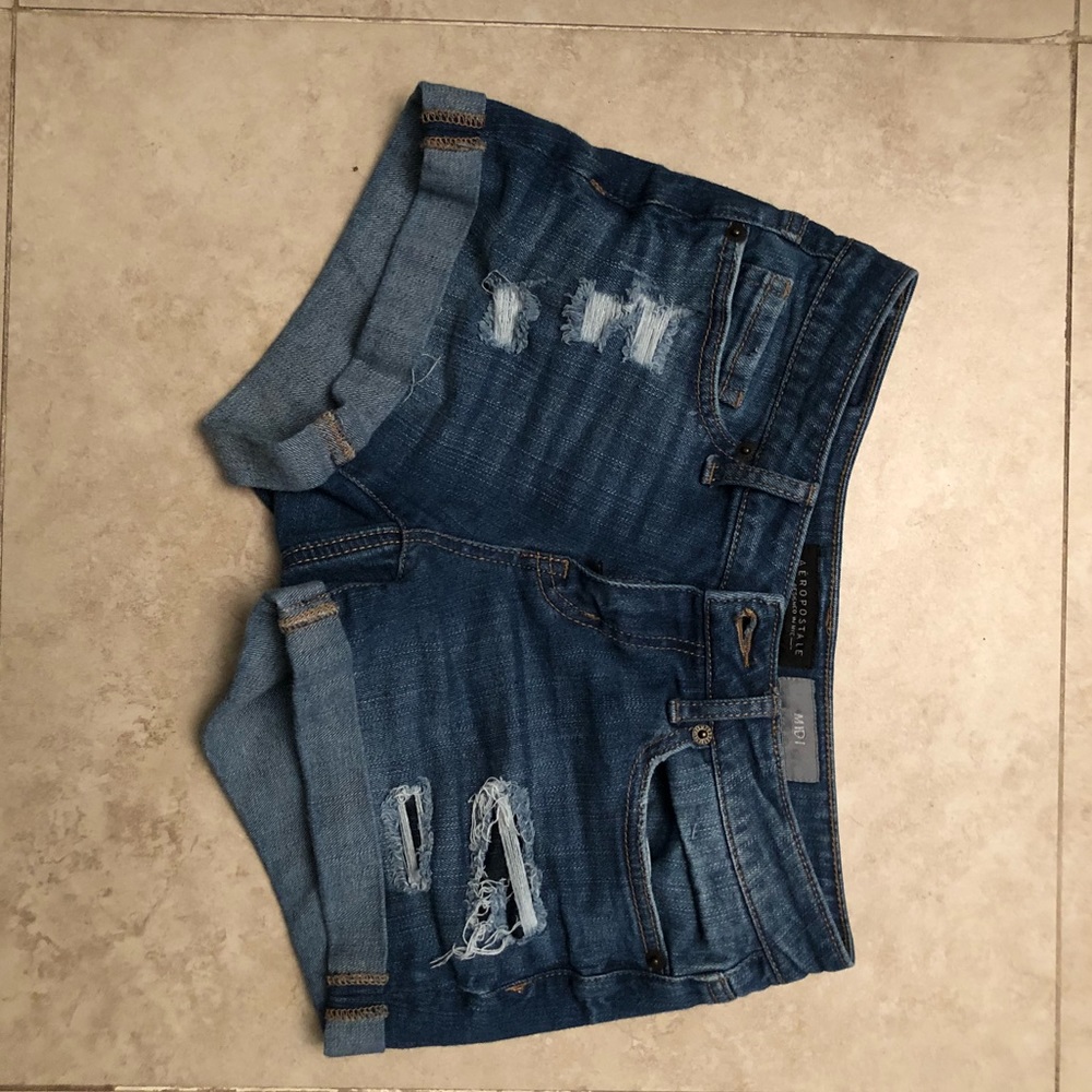 Medium wash destroyed denim midi shorts